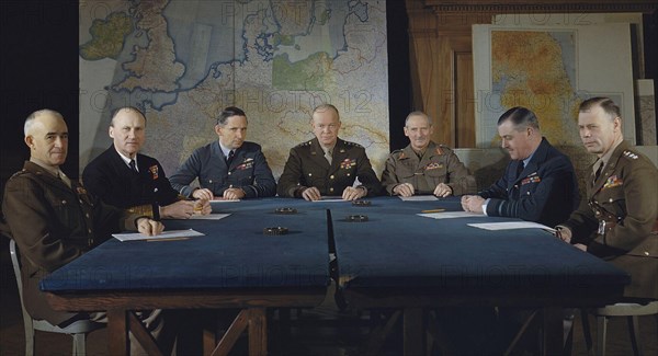 Left to right: Lieutenant General Omar Bradley, Commander in Chief, 12th US Army Group; Admiral Sir Bertram H Ramsay, Allied Naval Commander in Chief, Expeditionary Force; Air Chief Marshal Sir Arthur W Tedder, Deputy Supreme Commander, Expeditionary Force; General Dwight D Eisenhower, Supreme Commander, Expeditionary Force; General Sir Bernard Montgomery, Commander in Chief 21st Army Group; Air Chief Marshal Sir Trafford Leigh-Mallory, Allied Air Commander, Expeditionary Force; and Lieutenant General Walter Bedell Smith, Chief of Staff to General Eisenhower.