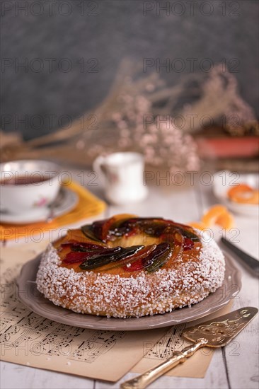 Rosca de reyes, king cake, glazed fruit, Provencal Galette des rois for the Epiphany on a wooden table