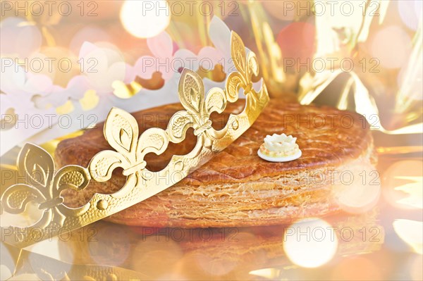 Galette des rois, french kingcake with a crown, holiday bokeh lights