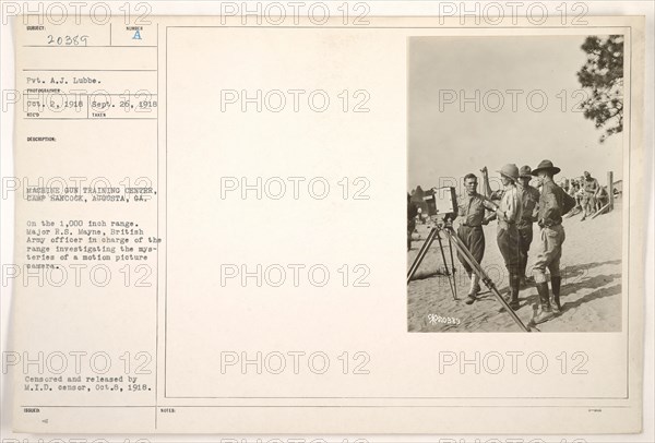 Major R.S. Mayne, a British Army officer, is seen investigating a motion picture camera at the Machine Gun Training Center in Camp Hancock, Augusta, Georgia. This image documents the military's interest in utilizing motion picture technology during World War I for training purposes. Photograph taken on September 26, 1918.