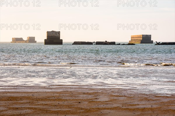 Remains of Phoenix caissons used to build the artificial Mulberry harbour on Gold Beach in Arromanches, France, after the Normandy landings in WWII.