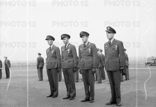 Royal Air Force- 2nd Tactical Air Force, 1943-1945. Four Norwegian fighter pilots standing to attention following the presentation of awards to each by Air Chief Marshal Sir Trafford Leigh-Mallory, Commander-in-Chief of the Allied Expeditionary Air Force, at North Weald, Essex. They are (left to right): Lieutenant-Colonel K Birksted, Commander of the Norwegian Wing, presented with the DSO; Major A Austeen, Commanding Officer of No. 331 (Norwegian) Squadron RAF, presented with the DFC; Major W Christie, Commanding Officer of No. 332 (Norwegian) Squadron RAF, presented with the DFC; and Captain
