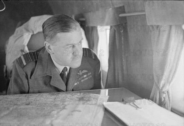 Royal Air Force- Headquarters Allied Expeditionary Air Force. The Commander-in-Chief of the Allied Expeditionary Air Force, Air Chief Marshal Sir Trafford Leigh-Mallory, looks down on Normandy from his Douglas Dakota, during his flight to see General Sir Bernard Montgomery at his Tactical Headquarters on the afternoon of 14 June 1944.