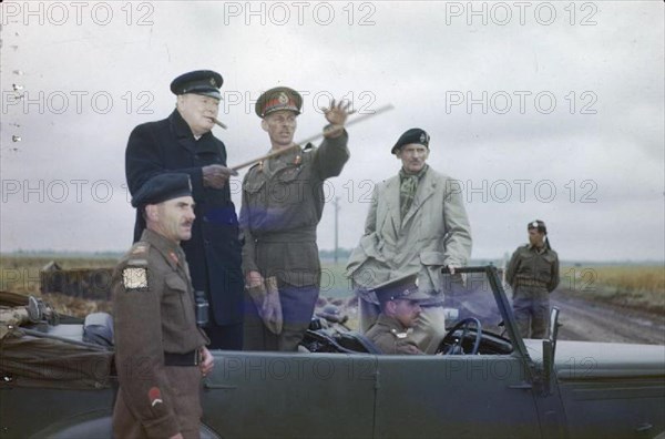 The Visit of the Prime Minister, Winston Churchill To Caen, Normandy, 22 July 1944 The Commander of the British 2nd Army, Lieutenant General Sir Miles Dempsey, pointing out a section of the front to the Prime Minister, the Rt Hon Winston Churchill, MP. Also in the picture are the Commander of the 2nd Canadian Corps, Lieutenant General G G Simonds (left) and the Commander of the 21st Army Group General Sir Bernard Montgomery (right).