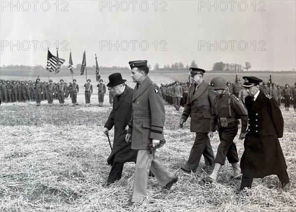 OPERATION OVERLORD PREPARATIONS   25 March 1944. From left: British Prime Minister Winston Churchill, US Generals Maxwell D. Taylor,  Dwight D. Eisenhower, Don F.  Pratt and  British Admiral Bertram Ramsay on an inspection of US forces at Greenham Common, Newbury, England.