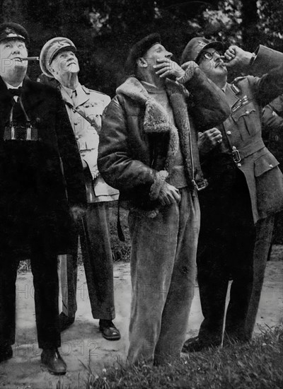 Winston Churchill, General Smuts, General Montgomery and Field Marshal Sir A Brook watch an air battle over the Cherbourg Peninsula. They visited a couple of weeks after D-day on the 6th June 1944, during the Second World War.