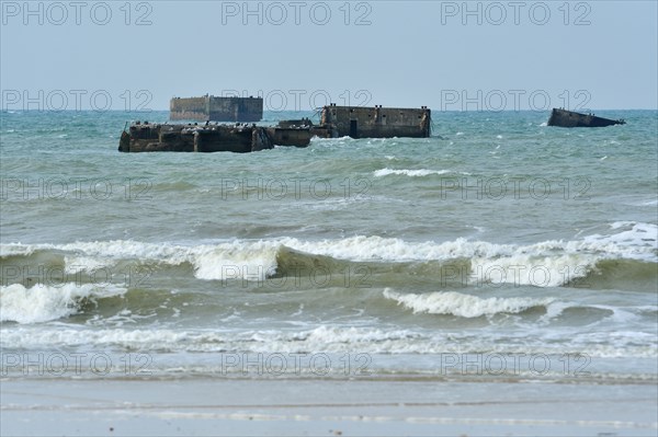 Second World War Two concrete boxes, known as Phoenix caissons in front of WW2 Gold Beach at Asnelles, Normandy, France