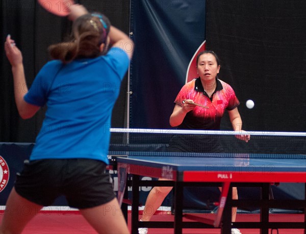 Jun Gao, who won a silver medal for China at the 1992 Barcelona Olympic Games, returns a serve at the U.S. Olympic table tennis trials in Cary, N.C., Feb. 12, 2012. Gao and three other American women will compete against Canada in the 2012 North American Olympic Games table tennis qualifying tourna