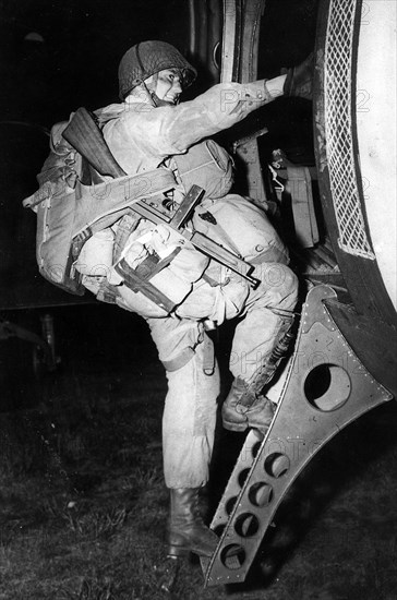 An American paratrooper boards his aircraft prior to D-Day 1944