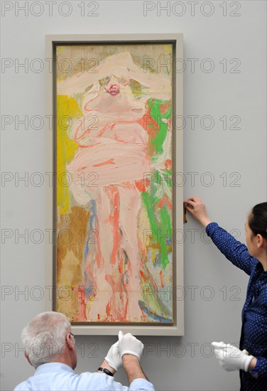 Museum employees hang the picture 'Woman with Hat' by Willem de Kooning for the upcoming exhibition 'Women' at the Pinakothek der Moderne in Munich, Germany, 22 March 2012. The exhibition with pictures by Picasso, Beckmann and de Kooning will run from 30 March till 15 July 2012. Photo: ANDREAS GEBERT