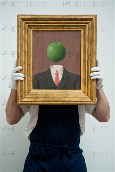 London, UK. 7th June 2013. A Sotheby's employee named Pietro holds “L’idee” by Rene Magritte (Est. 1.8 – 2.5million) during the preview of this summer auction at Sotheby's estimated at £100 million. Credit:  Piero Cruciatti/Alamy Live News