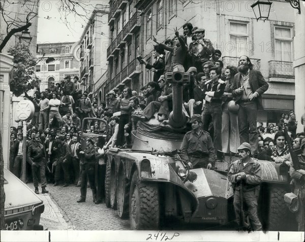 May 05, 1974 - The military uprising in Portugal.: Photo shows Jubilant Portuguese clamber aboard the armoured cars in Lisbon following the army take over in Portugal.