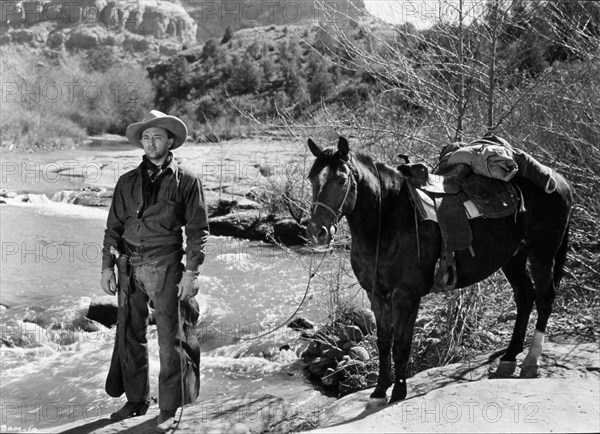 1948, Film Title: BLOOD ON THE MOON, Director: ROBERT WISE, Studio: RKO, Pictured: CLOTHING, HORSE, ROBERT MITCHUM, WESTERN, COWBOY, NATURE, RIVER, CHAPS, COWBOY HAT, NECK SCARF, DRIFTER, NOMAD. (Credit Image: SNAP)