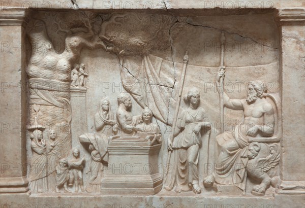 Munich Votive Relief. Greek votive relief from about 220 BC on display in the Glyptothek Museum in Munich, Bavaria, Germany. In a rural sanctuary a sacrificing family approach Asclepius, the god of healing, seated on a throne and his daughter Hygieia. In the middle there is an altar, to the left a sacred plane tree and in the background a pillar with two small figures of gods.