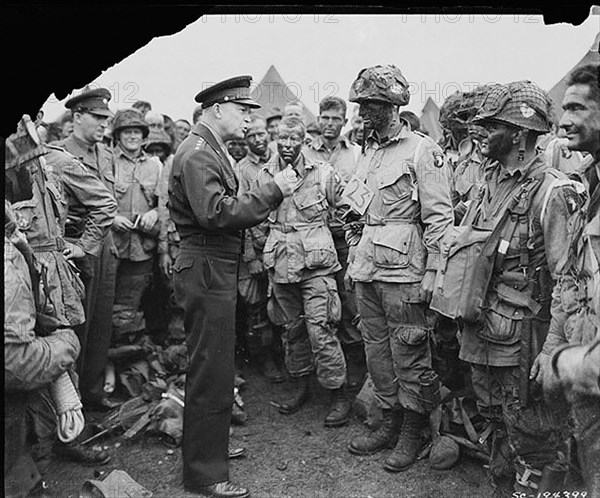 General Dwight D. Eisenhower gives the order of the Day.  "Full victory-nothing else" to paratroopers in England, just before they board their airplanes to participate in the first assault in the invasion of the continent of Europe.06/06/1944