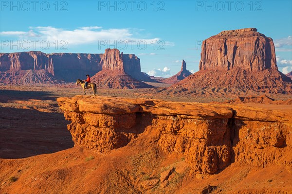 The John Ford's viewpoint inside the Monument Valley Navajo Tribal Park with a Navajo Horseman staging the scene of the movie Stagecoach, Arizona, USA