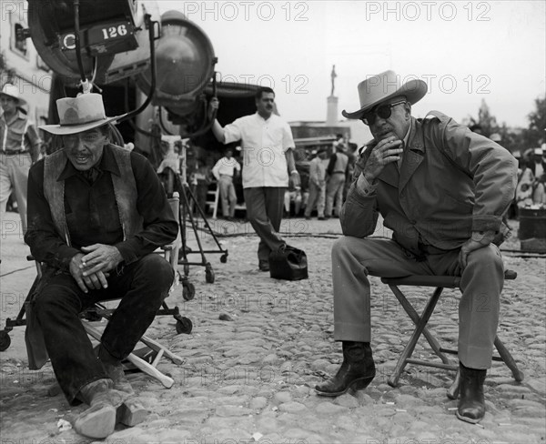 Clark Gable and director Raoul Walsh on the set of, "The Tall Men" 1955 20th Century Fox  File Reference # 33371_690THA