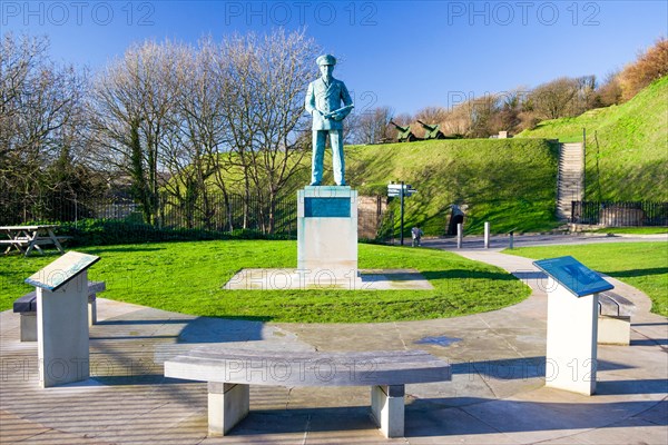 Statue of Vice Admiral Ramsay on the cliff top at Dover castle.Standing with one hand in pocket and the other holding a telescope. Wintertime. Blue sk