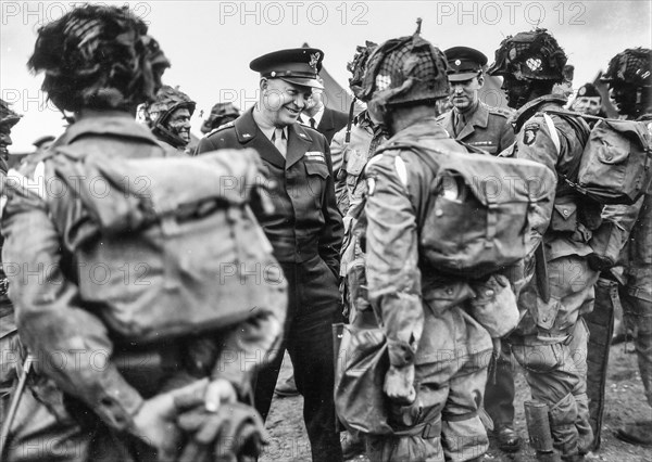 General Dwight D. Eisenhower gives the order of the day, "Full victory, nothing less" to paratroopers somewhere in England just before they board their planes to take part in the first assault of the invasion of France. England. June 6, 1944.