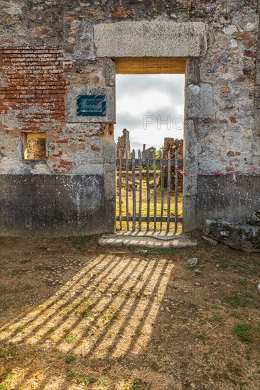 Europe, France, Haute-Vienne, Oradour-sur-Glane. Sept. 5, 2019. Sun shining through a doorway in ruined  building in the martyr village of Oradour-sur