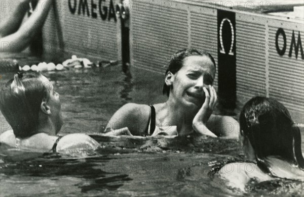American swimmer athlete Kaye Hall (center) weeps after having won the 100-meter backstroke at the Olympic Games, Mexico City 1968