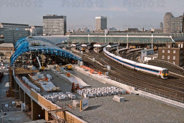 A Network SouthEast Class 442 Wessex electric departs London Waterloo and passes the ongoing construction work for the four new platforms to accommodate the soon to be introduced Eurostar trains. Once completed these new platforms would form Waterloo International railway station which opened on the 14th November 1994. 28th July 1992.