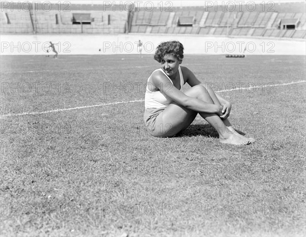 Female athlete sitting on the lawn in the Olympic Stadium ca. 1932