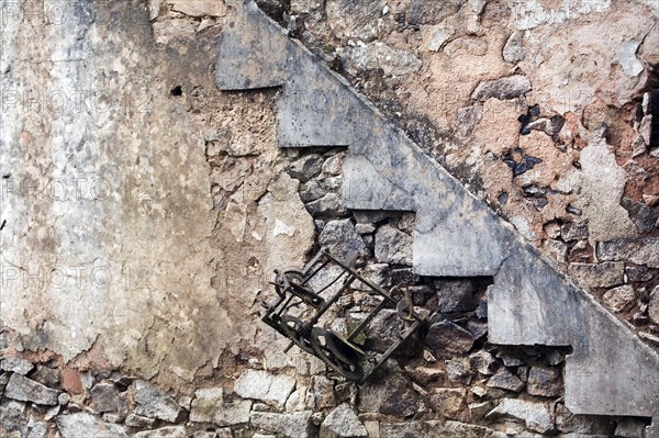 Destroyed the French village Oradour-sur-Glane. Interior with ruins of a clock and stair case.