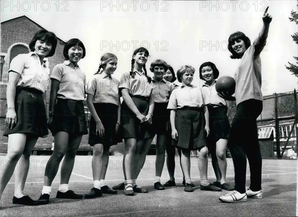 1964 - British Olympic 800 metres athlete and her Japanese pupils.: One of the British Olympic Team members of the 1964 Tokyo Olympics - in twenty two year old Anne - has been undergoing a strict training routine- with former world record holder Gordon Pirie as her coach. Anne, who is the daughter of a newspaper linotype operator is a teacher at t he Convent of the Sacred Heart - Hammersmith - with included in her pupils - a number of Japanese children-who have been giving Anne a few tips - on their own language. Photo shows Anne Smith talks to some of the Pupils - including the Japanese child