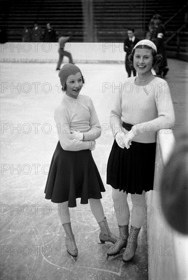 Winter Olympics 1936 - Germany, Third Reich - Olympic Winter Games, Winter Olympics 1936 in Garmisch-Partenkirchen.  Cecillia Colledge (right),  British  figure skater, Ladies Single with a figure skater colleague at the Olympic Ice sport center.  Image date February 1936. Photo Erich Andres