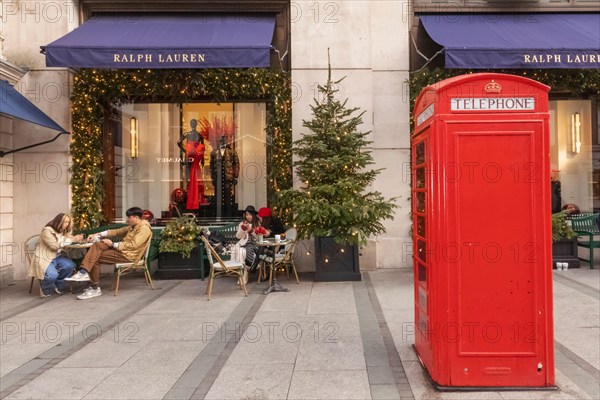 England, London, Piccadilly, New Bond Street, Exterior View of Ralph Lauren Store with Christmas Decorations and Traditional Red Telephone Box