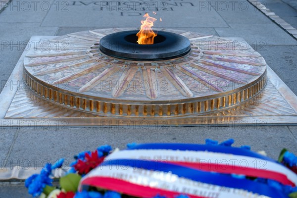 Paris, France - June 25, 2023 : View of the eternal flame at the tomb of the unknown soldier at the Arc de Triomphe in Paris France