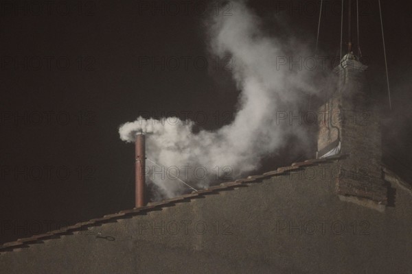 March 13, 2013 - Vatican City, Italy - White smoke rises from the chimney on the roof of the Sistine Chapel meaning that cardinals elected a new pope on the second day of their secret conclave on March 13, 2013 at the Vatican (Credit Image: © Future-Image/ZUMAPRESS.com)