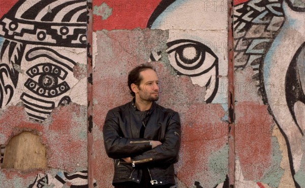 Jan 19, 2006; Mexico City, MEXICO; Mexican film maker, CARLOS REYGADAS' work is quintessentially Mexico City, here photographed in front of a decomposing mural on the streets of the historical center of Mexico City. His recent movie, 'Batalla en el Cielo' or 'Battle in Heaven,' was pulled from its original screening at the Sundance festival this year because of its opening scene, a young woman performing fellatio on an older, chubby man. The film was shown at other screenings as part of the festival and is scheduled to open Feb. 24 in Los Angeles. Reygadas won the Camera d'Or 'special mention