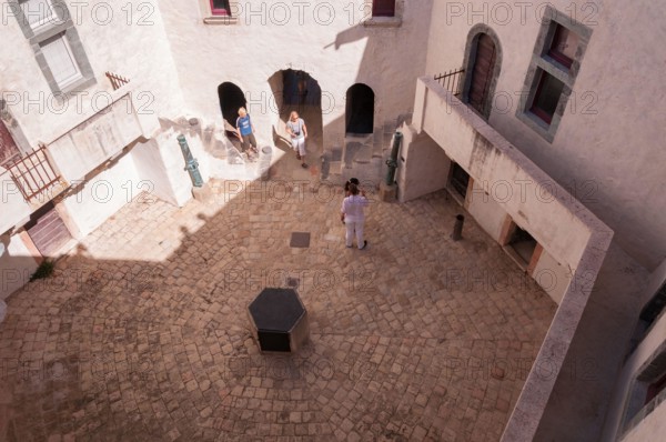 Tourists walking in the interior courtyard of La Citeadelle museum, Saint Tropez, France