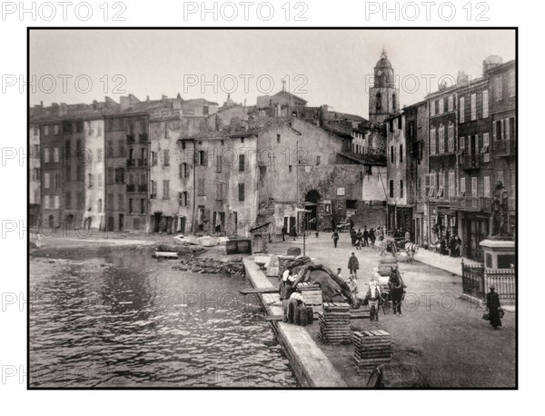 ST.TROPEZ VINTAGE RETRO 1900's Saint Tropez simple historic old fishing harbour port, with wooden fish boxes containers on harbour side waiting for the next fishing boat catch vessels, Cote d'Azur France
