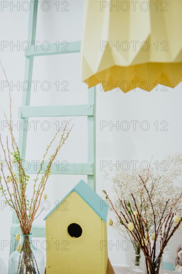 easter decoration. easter eggs with wooden feeder and mimosa.