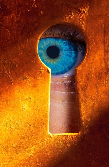 Eye peering through a keyhole