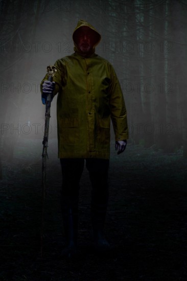 Wanderer of the night. Mysterious man walks through the forest at night.