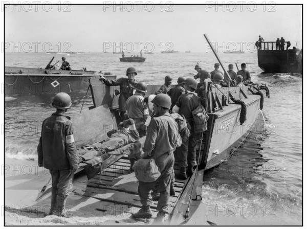 1944 WW2 St. Tropez wounded US soldiers are loaded onto a LCVP for transfer to hospital ship Invasion troops of U.S. Army establishes a beachhead in Saint-Tropez, France during World War II. Wounded U.S. soldiers are placed aboard LCVPs (Landing Craft, Vehicle, Personnel) South of France 1944 World War II Second World War