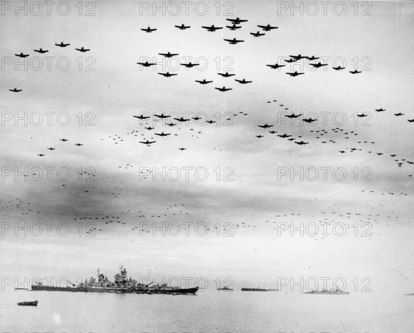 Massed formations of Vought F4U Corsair and Grumman F6F Hellcat planes fly over Tokyo Bay during the surrender ceremonies on the 2nd September 1945. The battleship USS Missouri, on which the surrender was signed,  is the large ship just left of centre. 9/2/1945