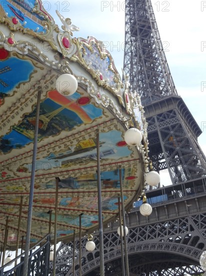 The eiffel tower in paris with the typical parisian carousel worth seeing at every season.
