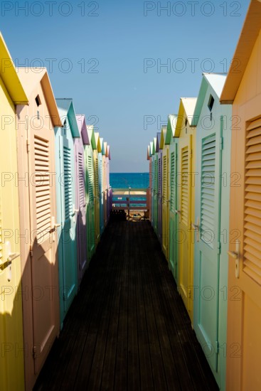 Group of colorful beach cabins in Italy.