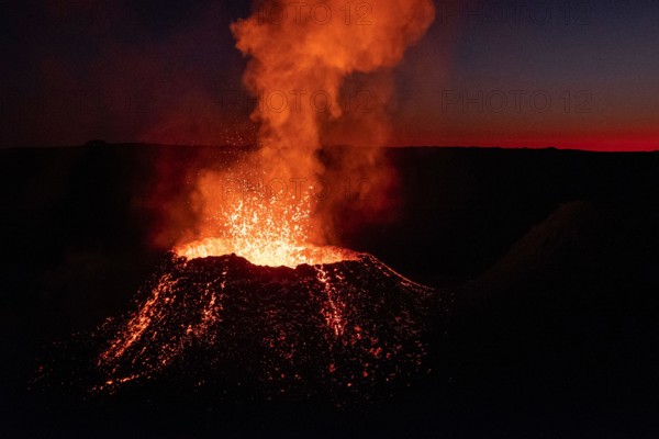 The Piton de la Fournaise volcano erupts on Reunion Island, shooting streams of molten lava high into the air under the cover of darkness.