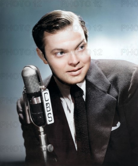 Portrait photograph of Orson Welles, promoting the premiere broadcast of Orson Welles and his Mercury Theater (Orson Welles Show) September 15, 1941, on CBS Radio - colorized photo