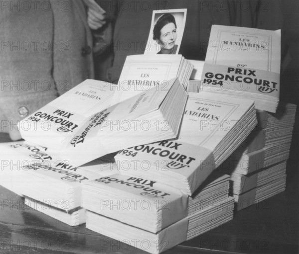 Dec 06, 1954; Unknown, UNKNOWN; (File photo) Simone de Beauvoir's portrait with copies of her book 'Les mandarins,' which won the 1954 Goncourt Prize.