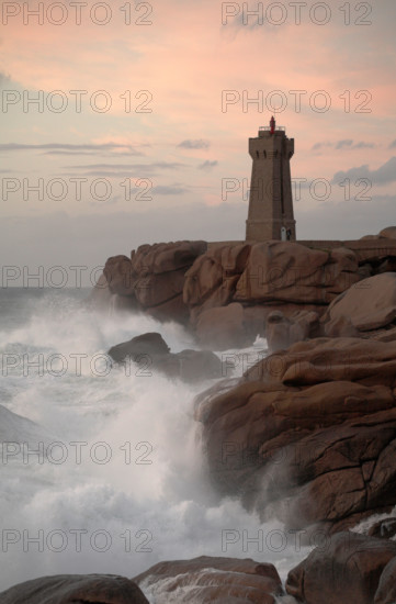 Lighthouse at Ploumanach on the Rose Granite coast Brittany France at Sunset
