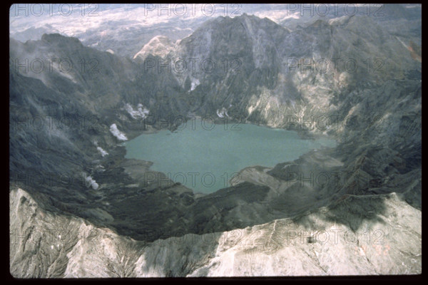 Mount Pinatubo's caldera and crater lake, formed after the catastrophic eruption in 1991, remains a significant geological site. The crater lake, located in the Philippines, was created by volcanic activity and is now a popular tourist destination. It showcases the recovery of nature after a volcanic event, surrounded by rugged terrain and lush vegetation.