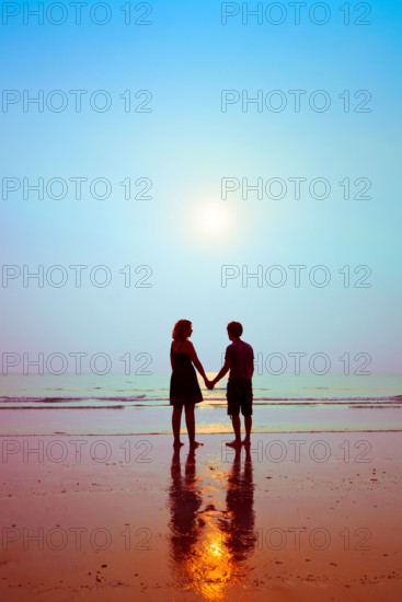 honeymoon, silhouettes of loving couple on the beach