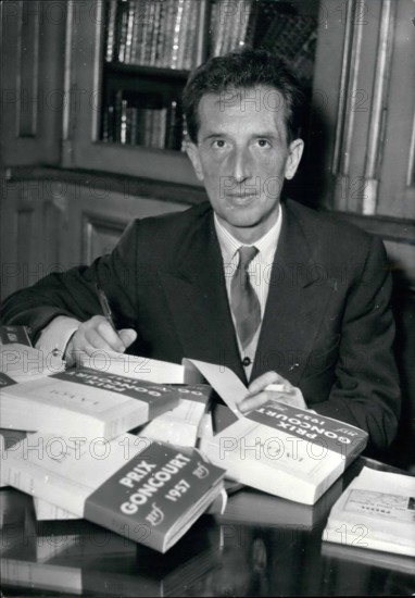 Dec. 12, 1957 - Prix Goncourt the most prized literary award goes to Roger Vailland. Roger Vailland, 50, writer and journalist, was awarded the Prix Goncourt, the famous literary awad, for his book La Loi today. Vailland's father was a farmer from French Savoy. OPS: Roger Vailland autographs his prize winning book at his publisher's this afternoon, Dec. 2nd/57
